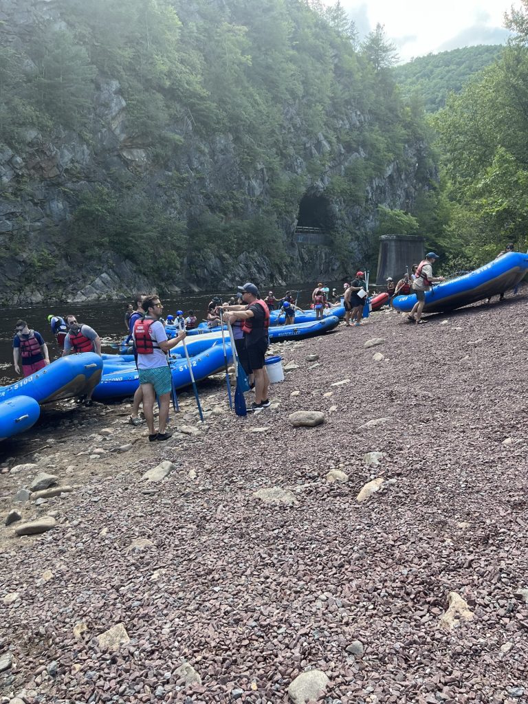 Groups preparing their rafts along the Lehigh River during a Pocono Whitewater rafting trip.